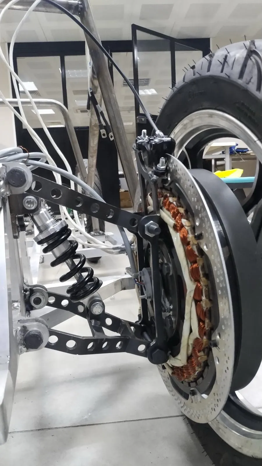 The motor mounted in the wheel hub, stator windings visible behind the brake disc